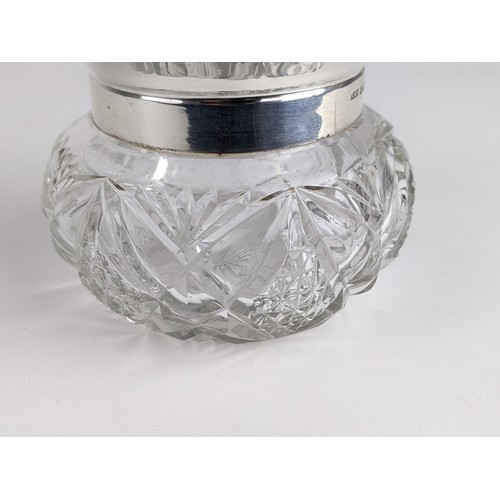 259 - An Edwardian cut glass and silver powder jar, the rim with a crimped edge and the lid engraved with ... 