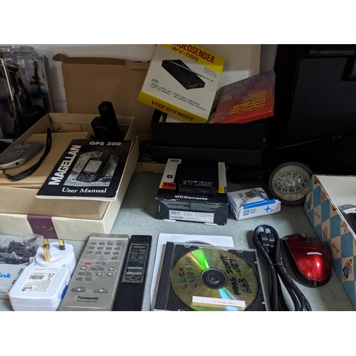 139 - A mixed lot of computer, gaming and other electrical accessories to include a Magellan GPS 300 with ... 