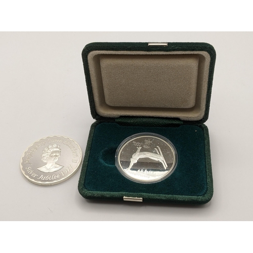 217 - A Canadian winter Olympic silver medallion together with a silver commemorative silver Jubilee medal... 