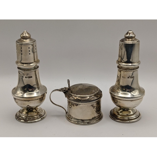 231 - An early 20th century silver mustard pot, together with matching silver salt and pepper shakers, 83.... 