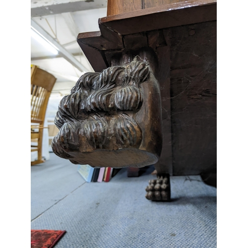 285 - Circa 1900, a walnut display cabinet having applied mouldings, fluted pillars on 2 front lion paw fe... 