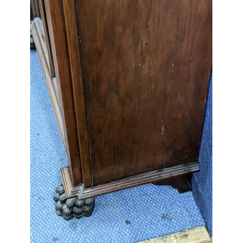 285 - Circa 1900, a walnut display cabinet having applied mouldings, fluted pillars on 2 front lion paw fe... 