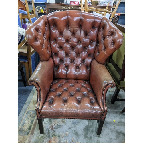 308 - A reproduction leather 'Chesterfield' button wing bang armchair
Location:A2M