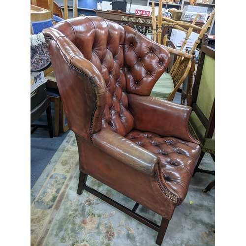 308 - A reproduction leather 'Chesterfield' button wing bang armchair
Location:A2M