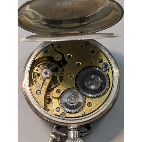 323 - An early 20th Century continental silver open faced pocket watch together with a white metal chain, ... 