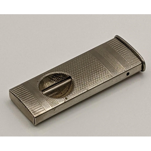 52 - A white metal cigar cutter having engine turned detail, total weight 14.5g Location:CAB1