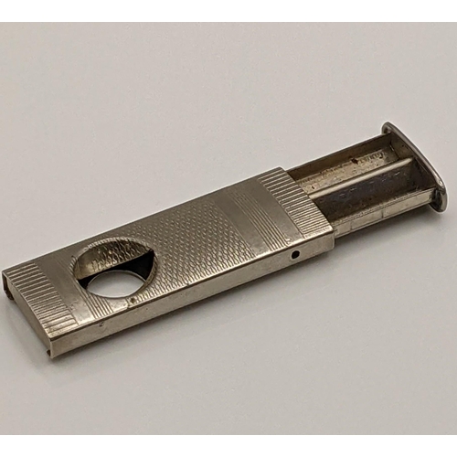 52 - A white metal cigar cutter having engine turned detail, total weight 14.5g Location:CAB1