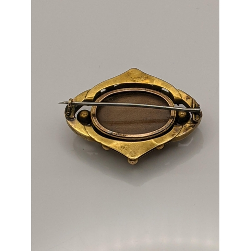 54 - A yellow metal mourning brooch set with a diamond, total weight including glass backing 7.8g Locatio... 