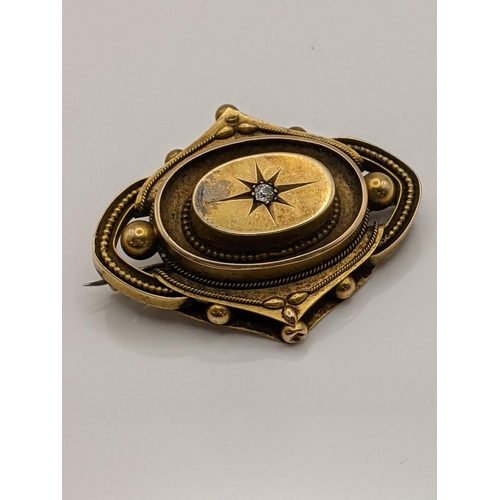 54 - A yellow metal mourning brooch set with a diamond, total weight including glass backing 7.8g Locatio... 