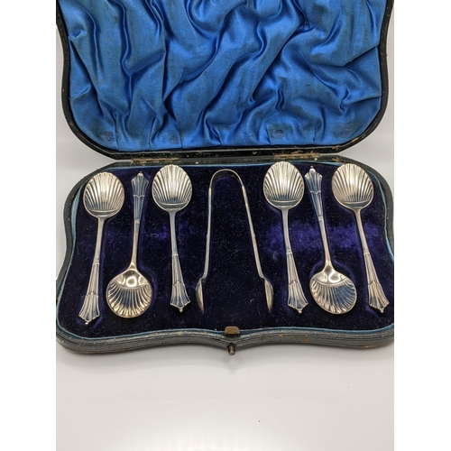 57 - Six silver teaspoons shell shaped, along with a pair of sugar tongs cased hallmarked London 1897, to... 