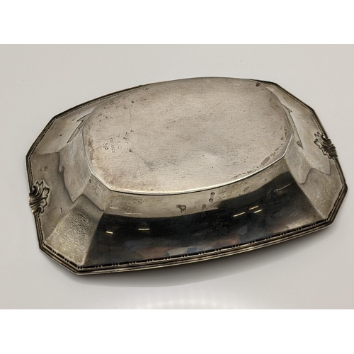 72 - An early/mid 20th century sterling silver octagonal formed dish having sausage and pea decoration an... 