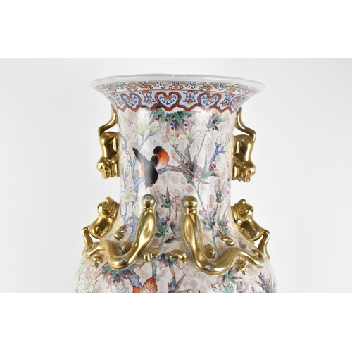 126 - A mid 20th century Chinese floor standing vase, of baluster form with dogs of Foo handles either sid... 