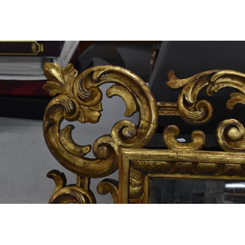 226 - A 19th century Italian giltwood mirror, the square bevelled glass within a c-scroll acanthus frame w... 