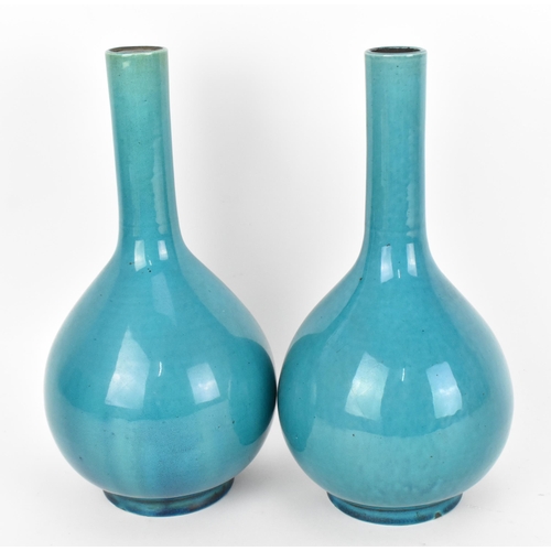 229 - A pair of Chinese turquoise glazed bottle vases, possibly 19th century, with cork to the top, on cir... 