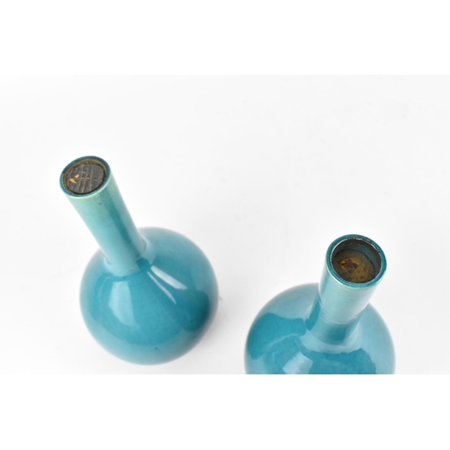 229 - A pair of Chinese turquoise glazed bottle vases, possibly 19th century, with cork to the top, on cir... 