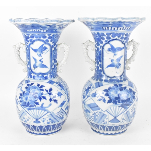 236 - A pair of Japanese export blue and white porcelain vases by Zoshuntei Sanpo Zu, shop owned by Hisato... 