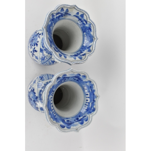 236 - A pair of Japanese export blue and white porcelain vases by Zoshuntei Sanpo Zu, shop owned by Hisato... 