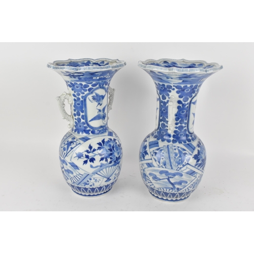 236 - A pair of Japanese export blue and white porcelain vases by Zoshuntei Sanpo Zu, shop owned by Hisato... 