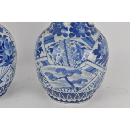 236 - A pair of Japanese export blue and white porcelain vases by Zoshuntei Sanpo Zu, shop owned by Hisato... 