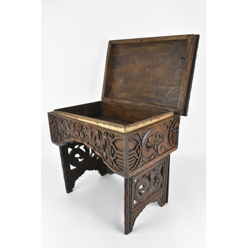 237 - A small Chinese hardwood folding travel table, with lift top revealing a storage compartment, the to... 