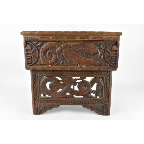 237 - A small Chinese hardwood folding travel table, with lift top revealing a storage compartment, the to... 