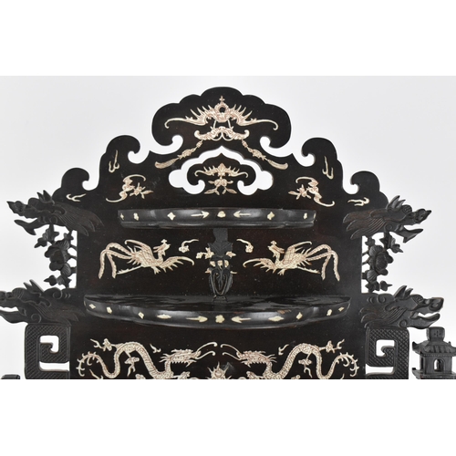 28 - A Chinese hardwood and bone inlay table cabinet, c.1900, the top section with two tiered shelving in... 