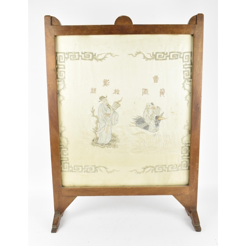 48 - A Chinese embroidered silk picture, framed within a hardwood fire screen, the embroidered image depi... 