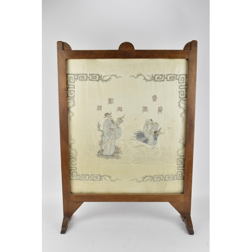 48 - A Chinese embroidered silk picture, framed within a hardwood fire screen, the embroidered image depi... 