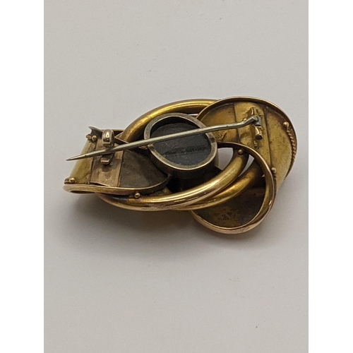 19 - A yellow metal mourning brooch in the form of a bow, total weight 15.8g, glass A/F Location:CAB5