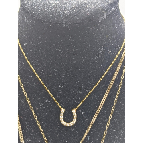 21 - Two yellow metal pendants, a 9ct gold necklace, along with a 14ct gold necklace, total weight 2.5g, ... 