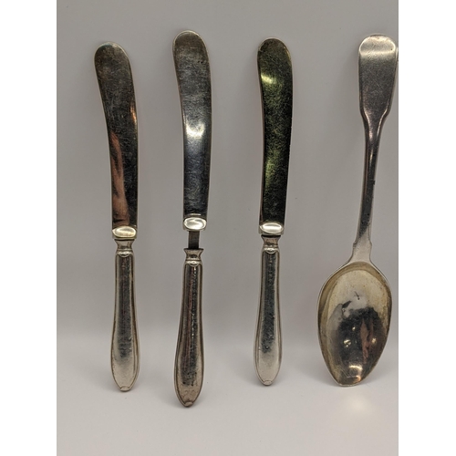 23 - A silver fiddle pattern spoon, hallmarked London 1815, together with six silver knives, hallmarked S... 