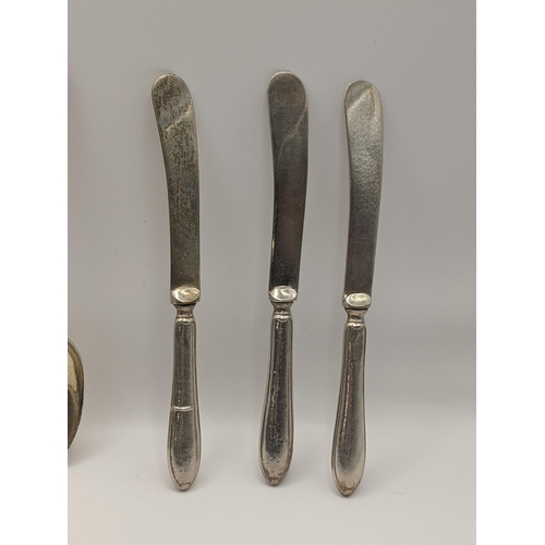 23 - A silver fiddle pattern spoon, hallmarked London 1815, together with six silver knives, hallmarked S... 