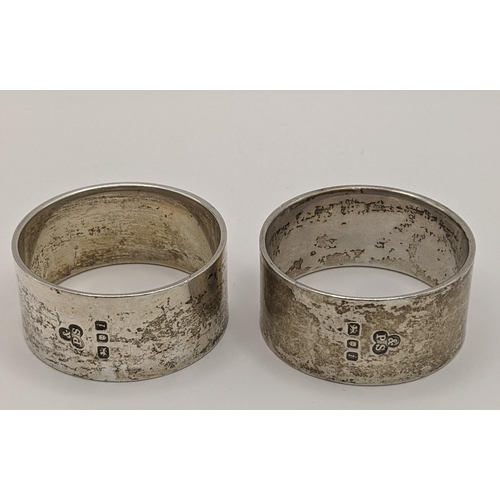 25 - Two silver napkin rings hallmarked London 1964, together with a European folk container brooch pin, ... 