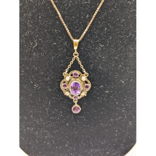 275 - A 9ct gold chain together with a late 19th/early 20th Century pendant set with an amethyst and seed ... 