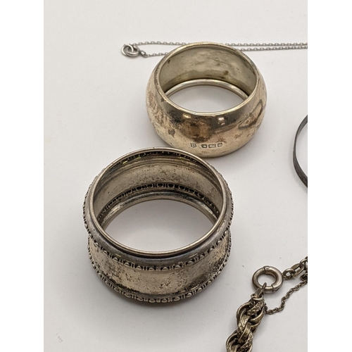 280 - A silver rope style bracelet together with 2 silver napkin rings, a white metal boot pendant togethe... 