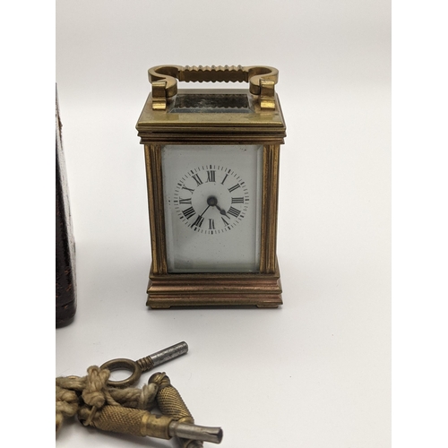 33 - An early 20th century French miniature carriage case clock with a travel case having a white enamel ... 