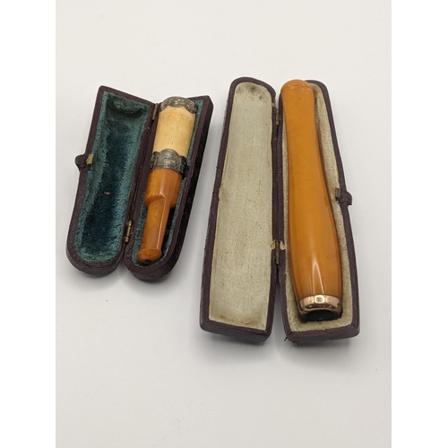 51 - A silver banded cigar holder having an amber mouthpiece, together with an amber cigarette holder Loc... 