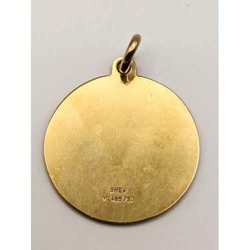 6 - A 18ct gold pendant with engraved detail of a mother with child, total weight 6.4g
Location:CAB3