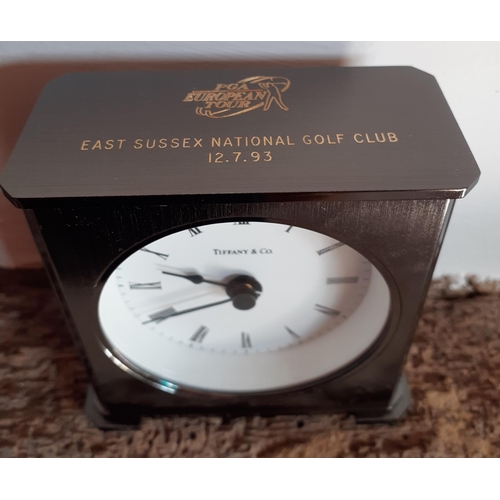 234 - Tiffany & Co-A small pewter coloured bedside clock with PGA European Tour inscription 'East Sussex N... 