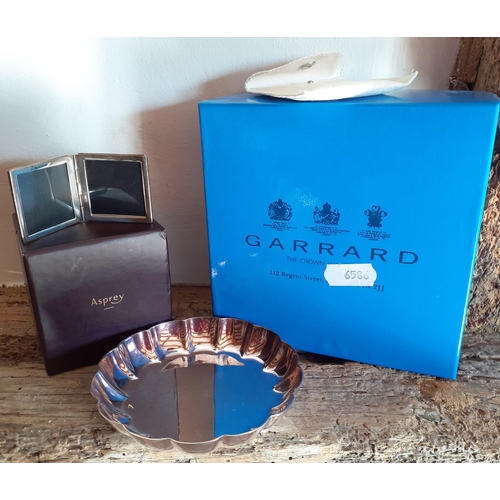 235 - Garrard & Asprey- A small Garrard silver plated dish with branded box and a small Asprey folding sil... 