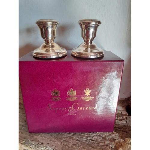 238 - Asprey-A pair of dwarf silver candlesticks in branded box. Location:TABLE2