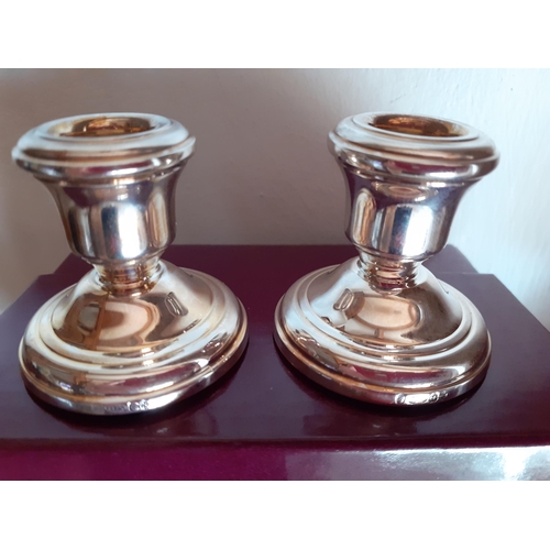 238 - Asprey-A pair of dwarf silver candlesticks in branded box. Location:TABLE2