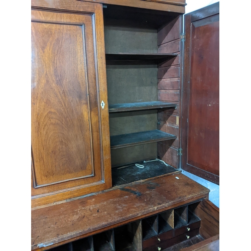 153 - A Georgian mahogany secretaire cabinet, the top with stepped cornice, twin fielded doors and three a... 