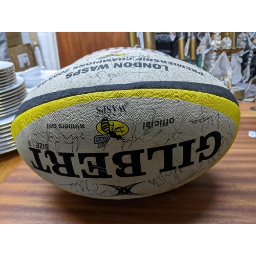 160 - A 2003/04 Wasps rugby ball signed by members and a match played rugby ball Location:G