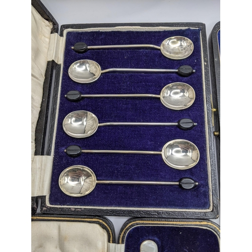 247 - A silver cased christening set 50g, together with a cased set of six silver teaspoons, and sugar ton... 