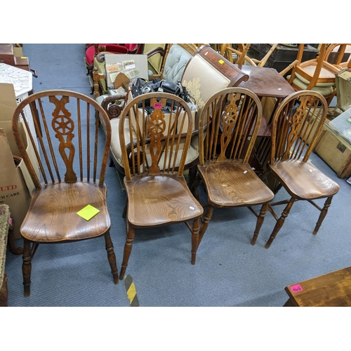 597 - A set of four early/mid 20th century elm and ash wheel spindle back dining chairs A3F