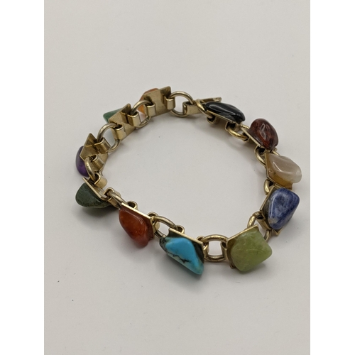 206 - A gold plated bracelet set with semi-precious stones to include amethyst, turquoise and others
Locat... 