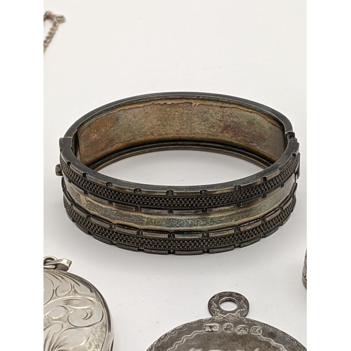 208 - A mixed lot of silver and white metal to include a white metal bangle having initials to the reverse... 