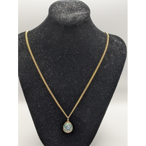 233 - A 9ct gold chain, 13g, together with a silver egg pendant with floral detail and blue and green enam... 