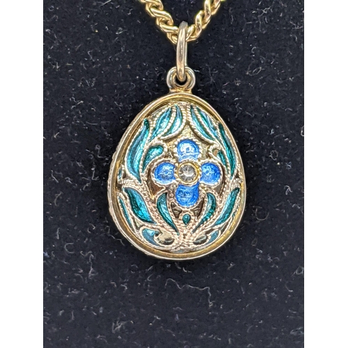 233 - A 9ct gold chain, 13g, together with a silver egg pendant with floral detail and blue and green enam... 